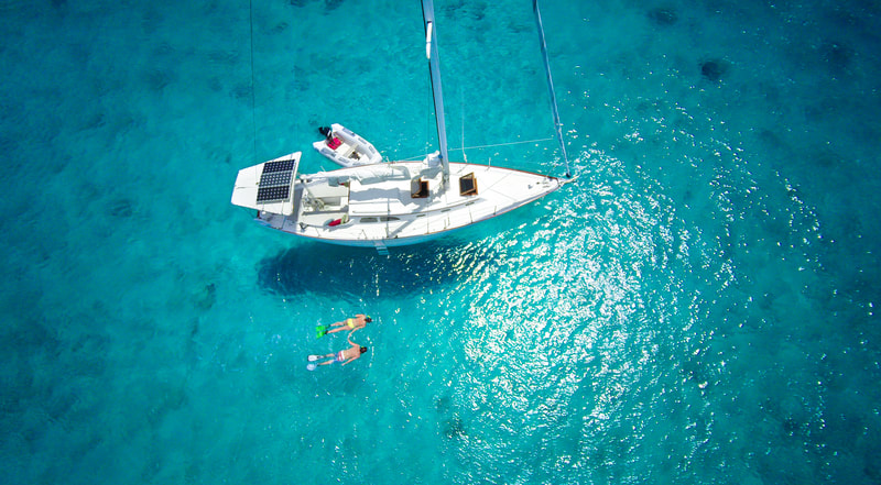 couple snorkeling next to boat